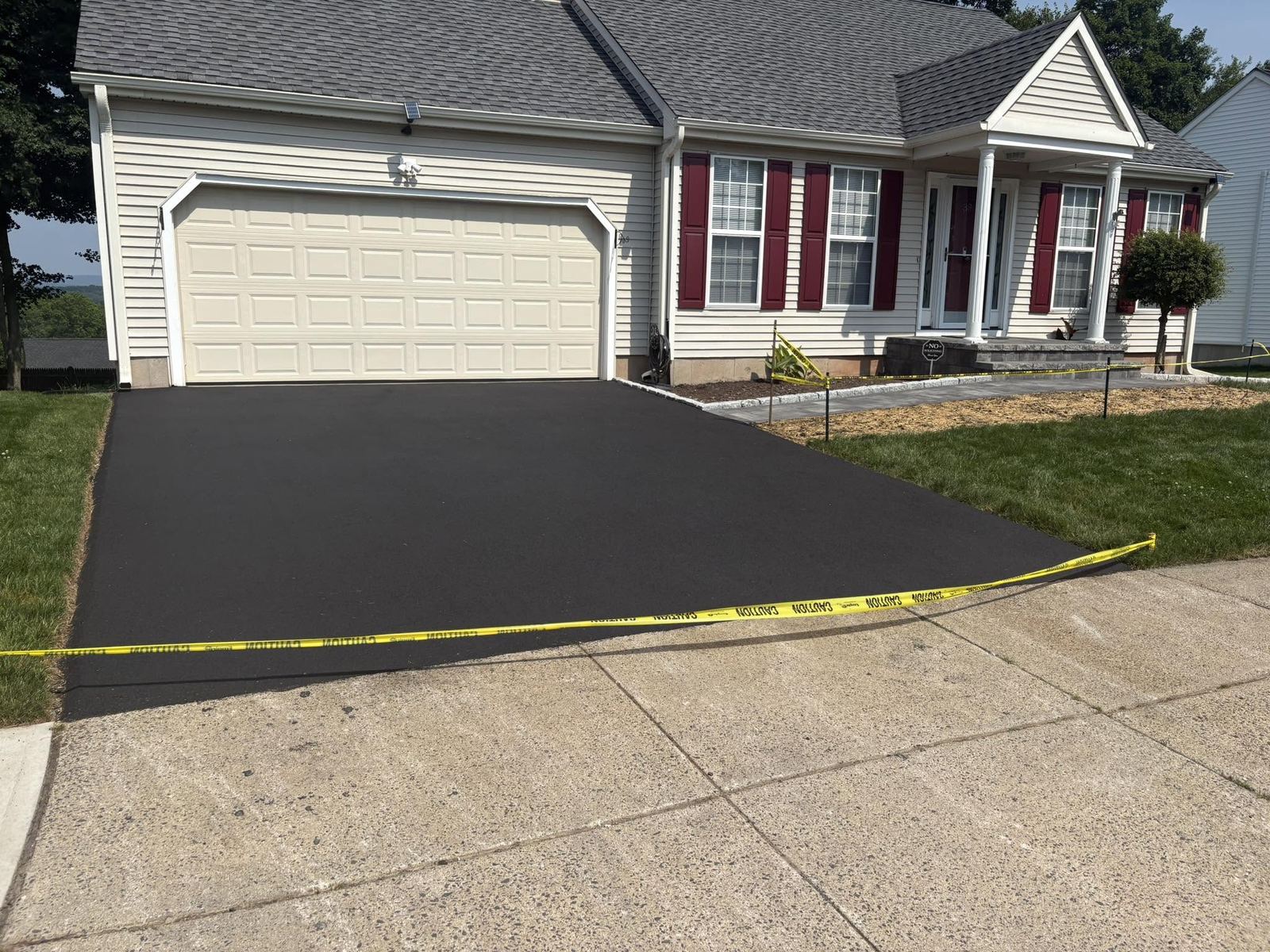 Freshly paved black asphalt residential driveway