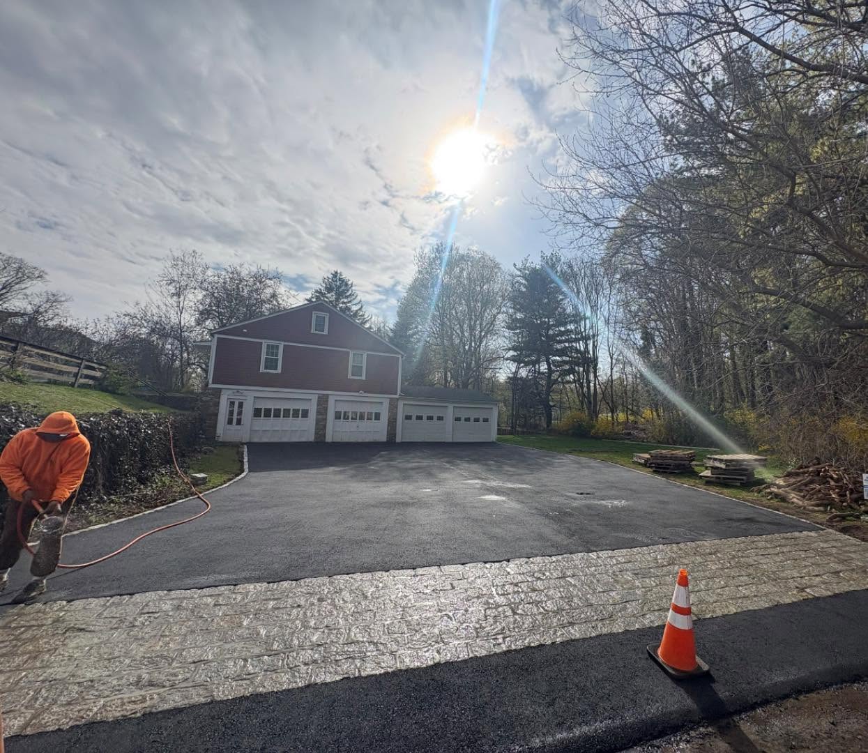 Asphalt driveway with a decorative stamped-concrete apron
